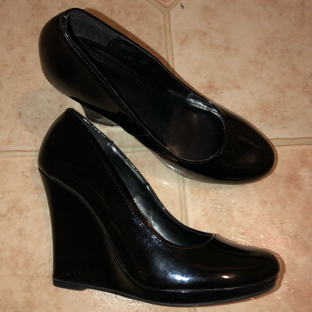 Black patent leather wedge heels.